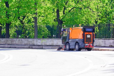 1.07.2021 Russia St. Petersburg. Sweeper in the process of cleaning street sweeping. The municipal service is cleaning up the city