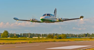 Krasnodar - Cessna 340 passes over the runway during a demonstration flight.  clipart