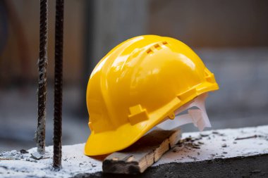 İnşaat alanında inşaat alanında mühendislerin korunması için inşaat alanında çalışan işçilere inşaat başlığı güvenlik aletleri inşa edilecek. Sarı başlık.
