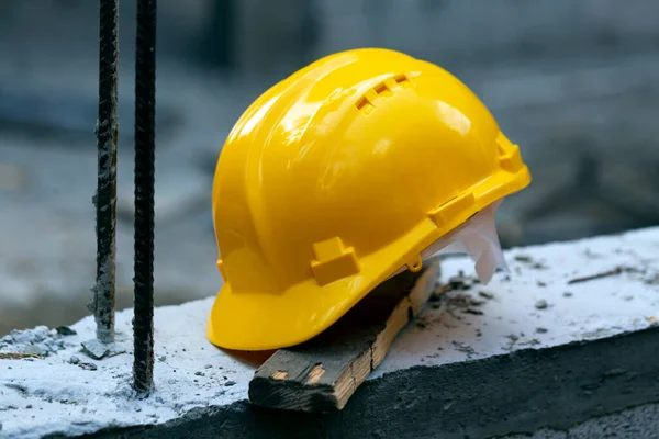 Construction hard hat safety tools equipment for workers in construction site for engineering protection head standard on building construction background. Yellow helmet.