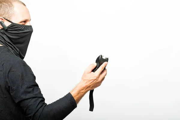 Electroshock Taser in hand isolated on white background. Stun gun, taser, electroshock protection against bandits, device for self-defense. Man with a lightning high voltage stun gun