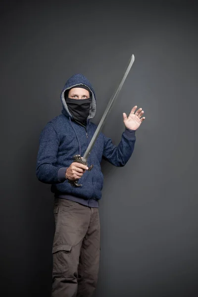 American Brutal Man Blue Hoodie Black Face Mask Japanese Sword —  Fotos de Stock