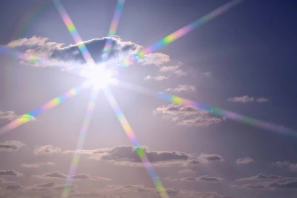 The sun's rays with sunbeam shine above for natural light effects. Blue sky with clouds and sun reflection in water with place for text, backgrounds for design. Sun Flares nature, blinking sun burst