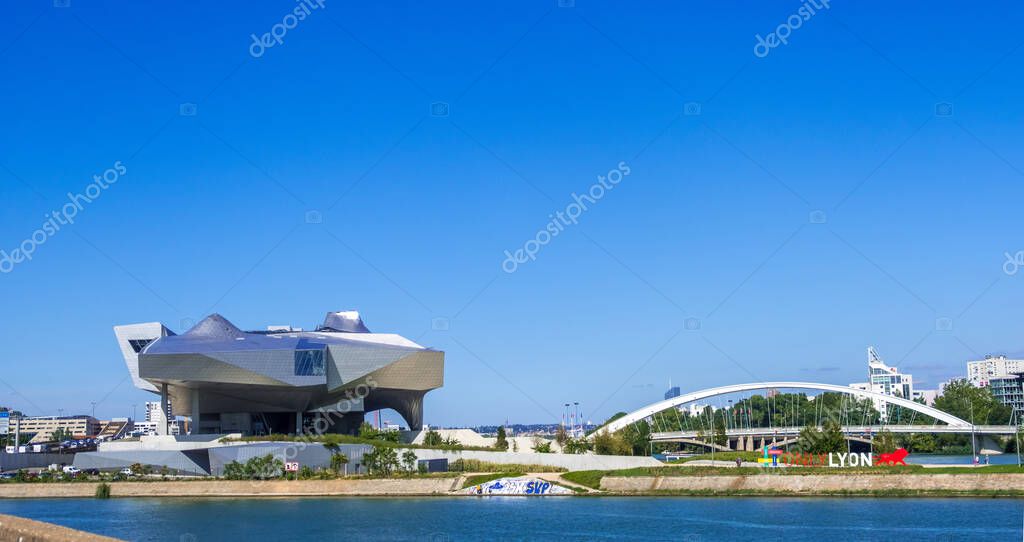 Lyon, France - August 22, 2019: Musee des Confluences museum. The Pont Raymond Barre bridge over the Rhone river and a Only Lyon slogan of Lyon city