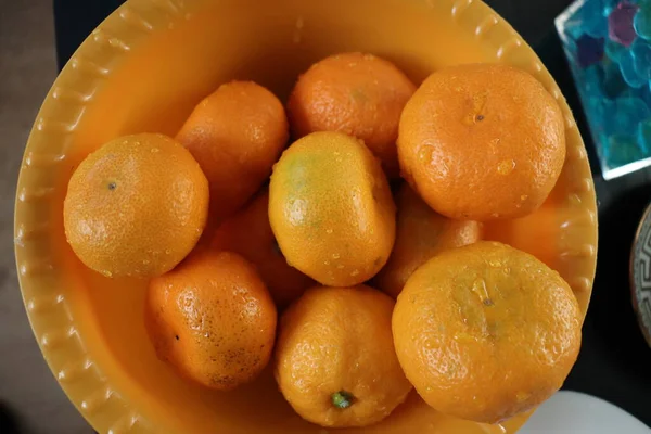 tangerines in an orange bowl