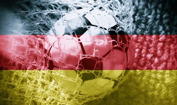 German flag with a soccer ball going inside the net. Concept of German soccer team.