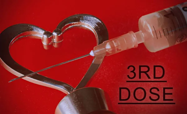 Close Syringe Heart Red Background Text Third Dose — Stock Photo, Image