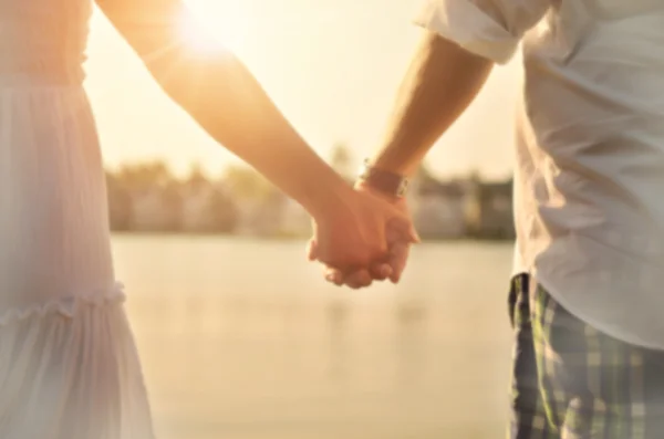 Blur couple holding hand on tropical sunset beach — Stock Photo, Image