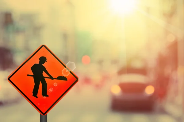 Construction sign on blur car country road — Stock Photo, Image