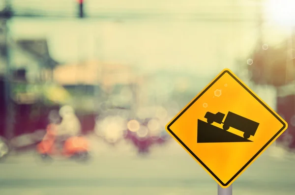 Traffic sign, up hill on blur road — Stock Photo, Image