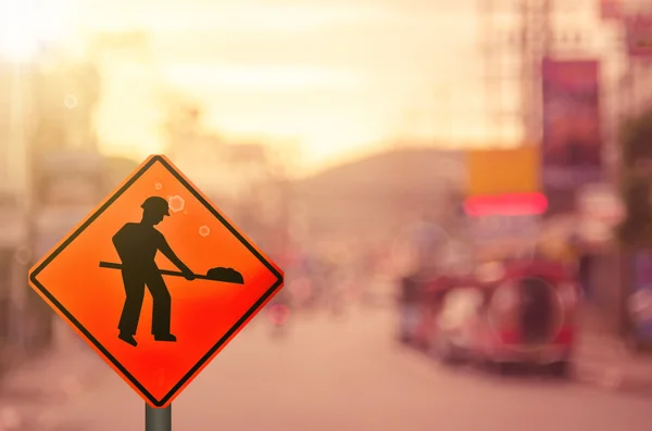 Construction sign on blur car country road — Stock Photo, Image