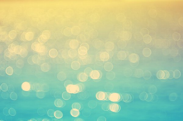 Blur tropical sunset beach with bokeh sun light wave abstract background. Travel concept. Retro color style.