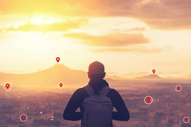 Backpacker man standing at top of mountain looking view landscape with navigator gps location abstract background. Copy space travel adventure holiday and technology business concept. Vintage color.