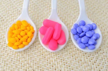 colorful medicine tablet on the spoon clipart
