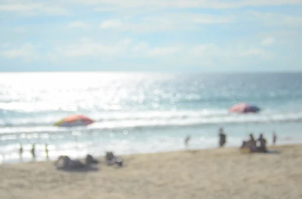 Ombrello sfocato sulla spiaggia sfondo astratto — Foto Stock