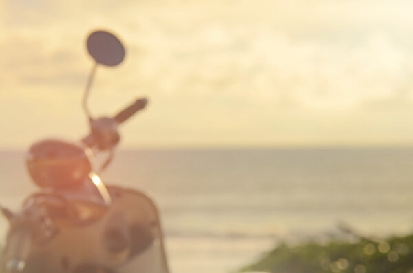 Blur motorcycle on sunset beach abstract background.Travel concept.