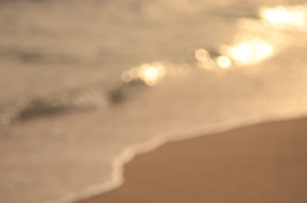 Oskärpa bokeh våg stranden abstrakt bakgrund — Stockfoto