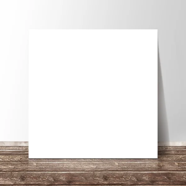 Blank white square paper template banner on the wooden floor against the wall — Stock Photo, Image