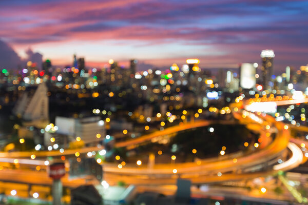 Abstract blurred bokeh light at twilight, city downtown background and highway interchanged at twilight