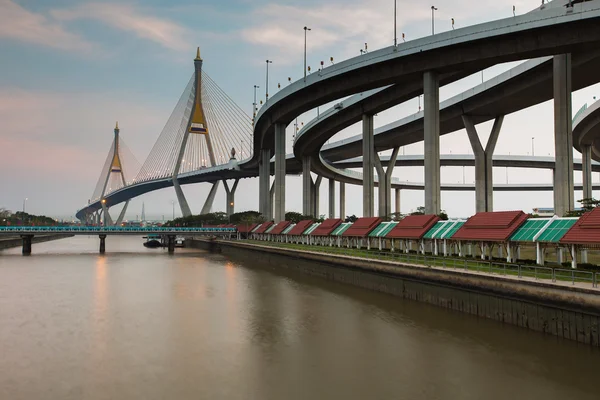 Twin Suspension bridge connect to highway interconnection river front — Stock Photo, Image