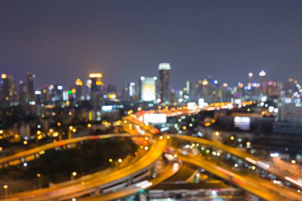 Blurred bokeh highway intersection and office building background, night view — Stock Photo, Image