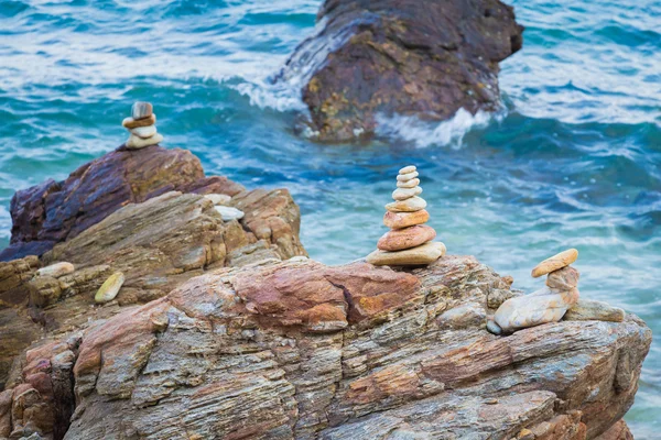 Stone stack on the rock with ocean background