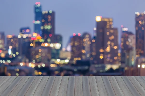 Opening wooden floor, Blurred bokeh business district lights at night — Stock Photo, Image