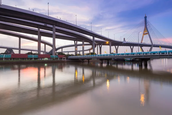 Puesta de sol sobre puente colgante conectar a la carretera intercambiado — Foto de Stock