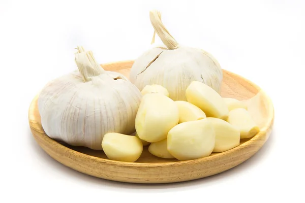 Garlic on wooden plate — Stock Photo, Image
