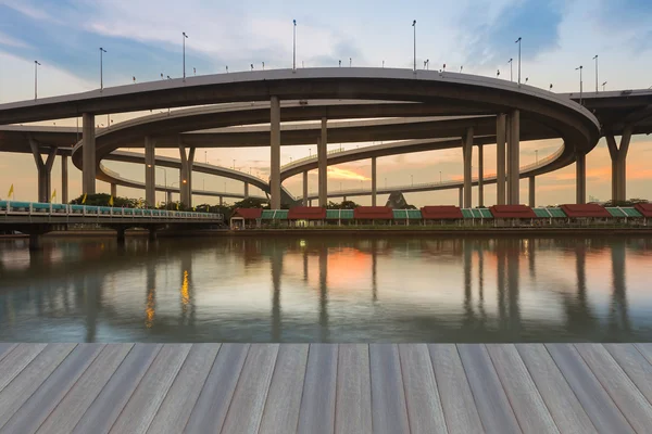 Highway interchanged river front with sunset sky