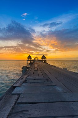 Okyanus güzel günbatımı gökyüzü arka plan ile önde gelen ahşap yürüyüş yolu