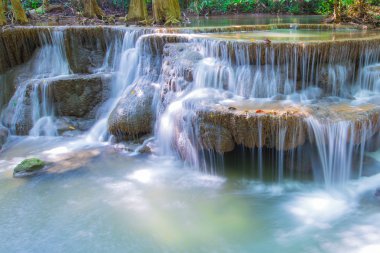 Water fall in spring season located in deep rain forest jungle