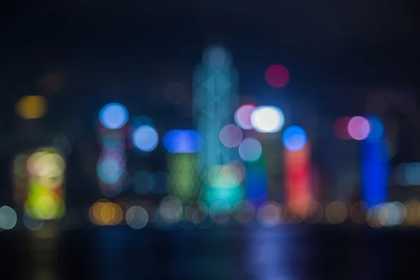 Skyline van Hongkong op nacht - wazig foto bokeh — Stockfoto