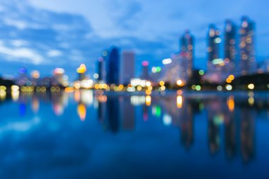 Abstract blur bokeh city twilight background with water reflection