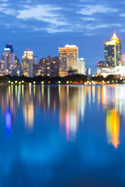 Dämmerung des Stadtlichts Bokeh in der Dämmerung mit Wasserreflexion — Stockfoto