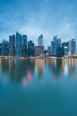 Singapores business district at twilight with water reflection