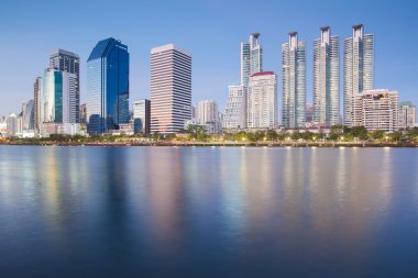 Bangkok city downtown twilight with water reflection of skyline Benjakitti Park  Bangkok Thailand