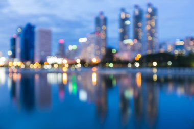 Bokeh city lights during twilight with water reflection