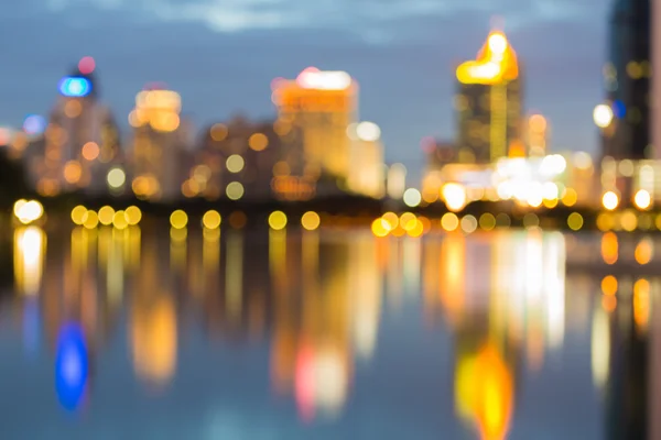 Abstract city bokeh lights during blue hours, with water reflection — Stock Photo, Image