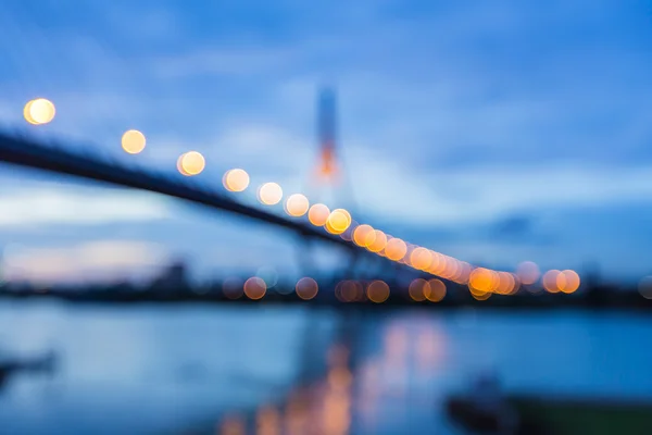 Abstract blurred bokeh light, the bridge river front view at nigth — Stock Photo, Image