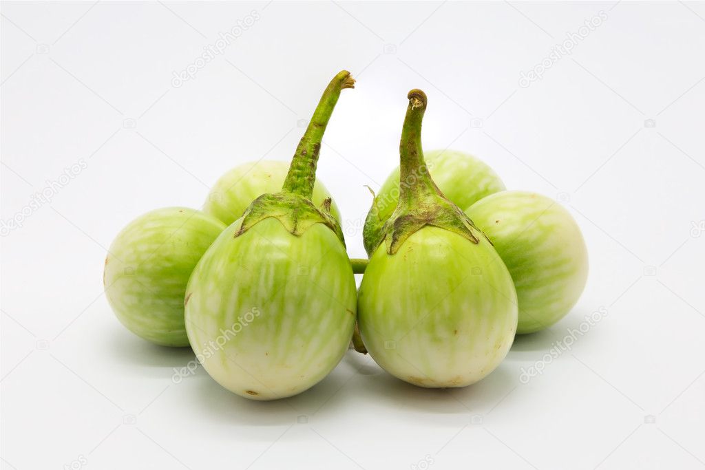 Fresh organic green eggplant on white