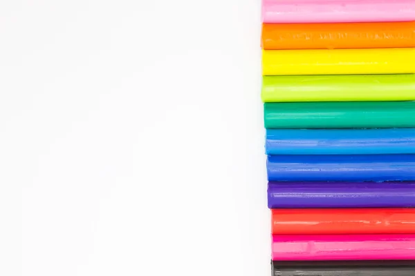 Art rainbow colour clay sticks on right of white background — Stock Photo, Image