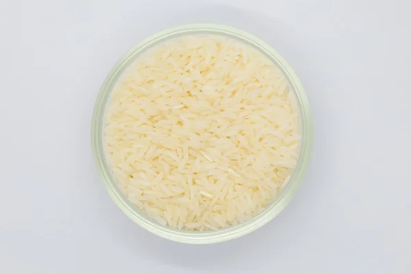 White rice in glass bowl on white — Stock Photo, Image