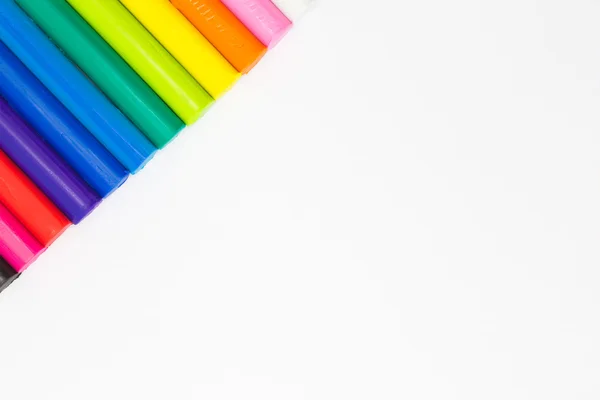 Rainbow colour of art clay sticks top left coner side of white background — Stock Photo, Image