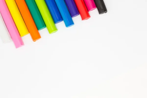 Multiple colour of clay sticks on top left conner white background — Stock Photo, Image