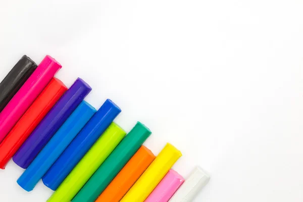 Multiple colour of clay sticks on left down conner white background — Stock Photo, Image