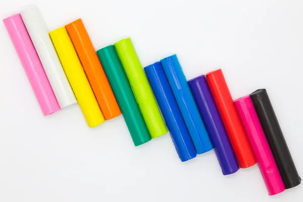 Ranibows color plasticine sticks for children playing on white background — Stock Photo, Image