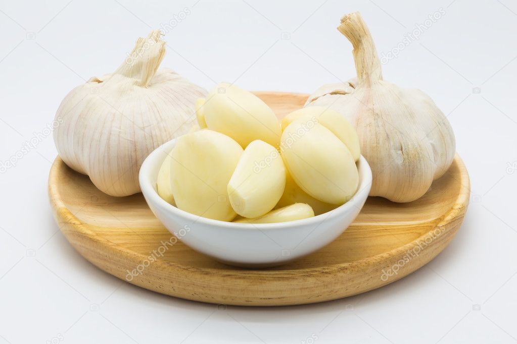 Fresh Garlic on wooden plate ready for cooked