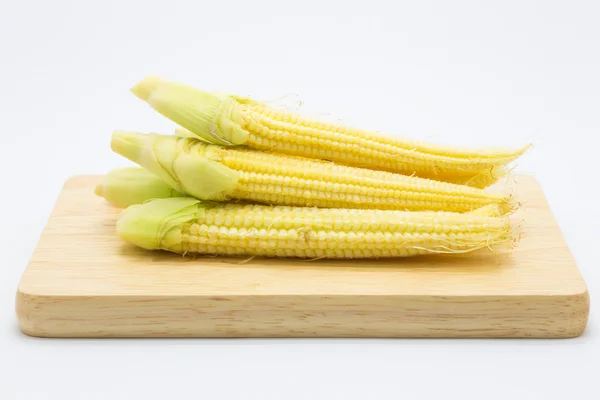 Baby corn on wooden plate, on white — Stock Photo, Image