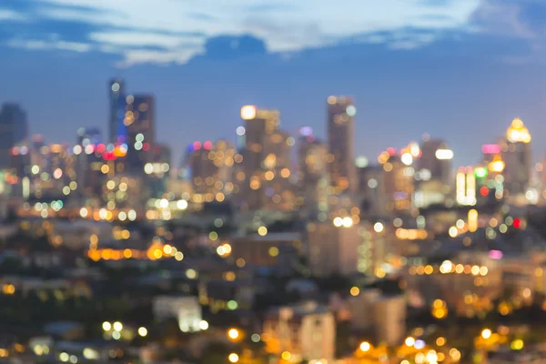 Resumen borroso bokeh luz ciudad área de negocios con crepúsculo cielo fondo —  Fotos de Stock